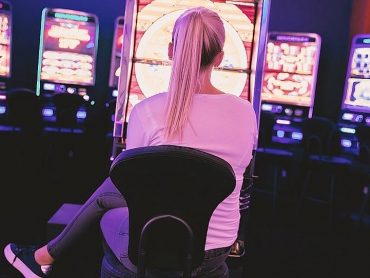 Blonde playing at a slot machine