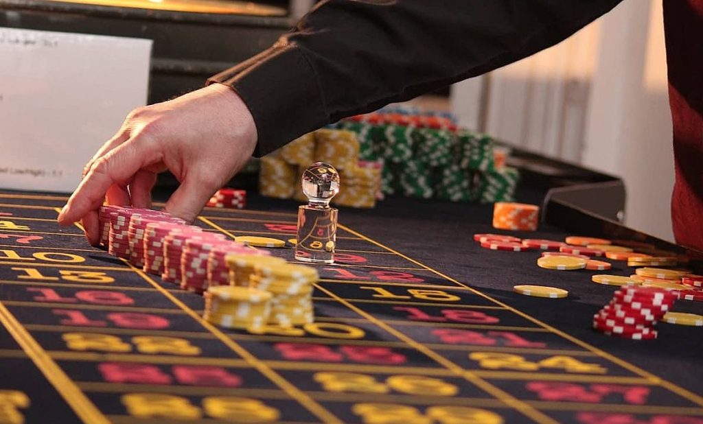 Man in black shirt is playing poker